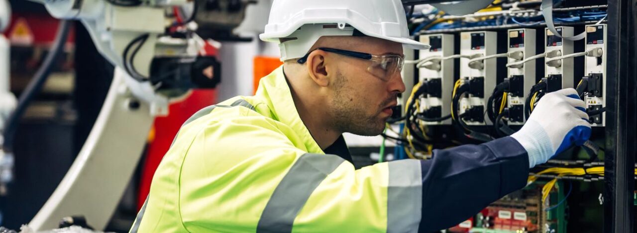 Technician Engineer Holding Robot Controller Checking And Repairing Automatic Robotic Machine At Industrial Factory, Worker Working With Robotic Arm System In Factory